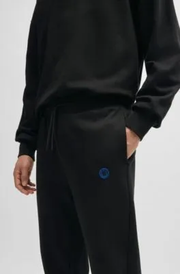 Cotton-terry tracksuit bottoms with Happy HUGO logo patch