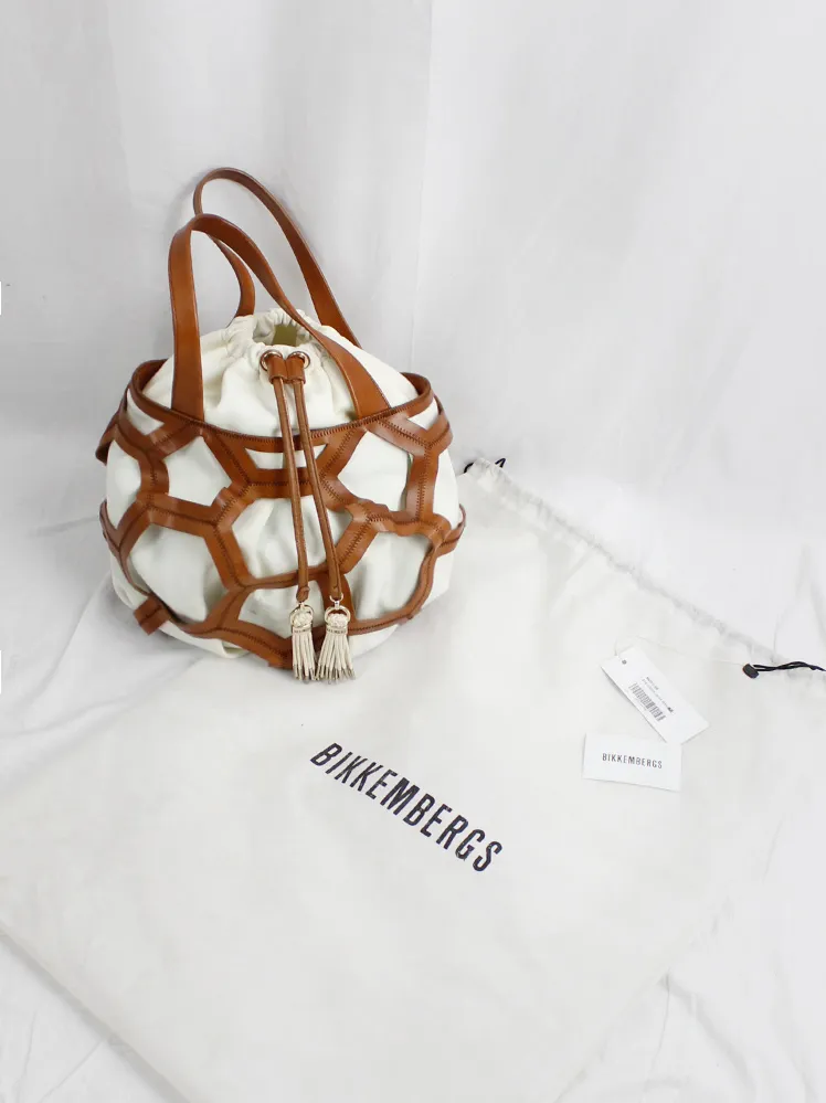 Dirk Bikkembergs brown leather football bag with hexagonal cutouts over a white fabric bag