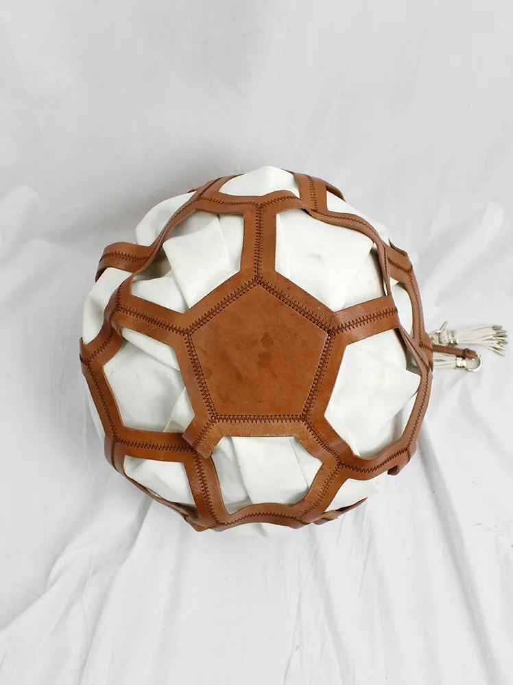 Dirk Bikkembergs brown leather football bag with hexagonal cutouts over a white fabric bag