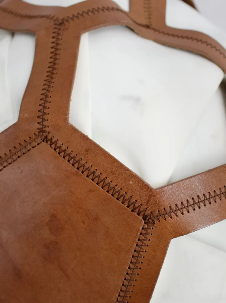 Dirk Bikkembergs brown leather football bag with hexagonal cutouts over a white fabric bag