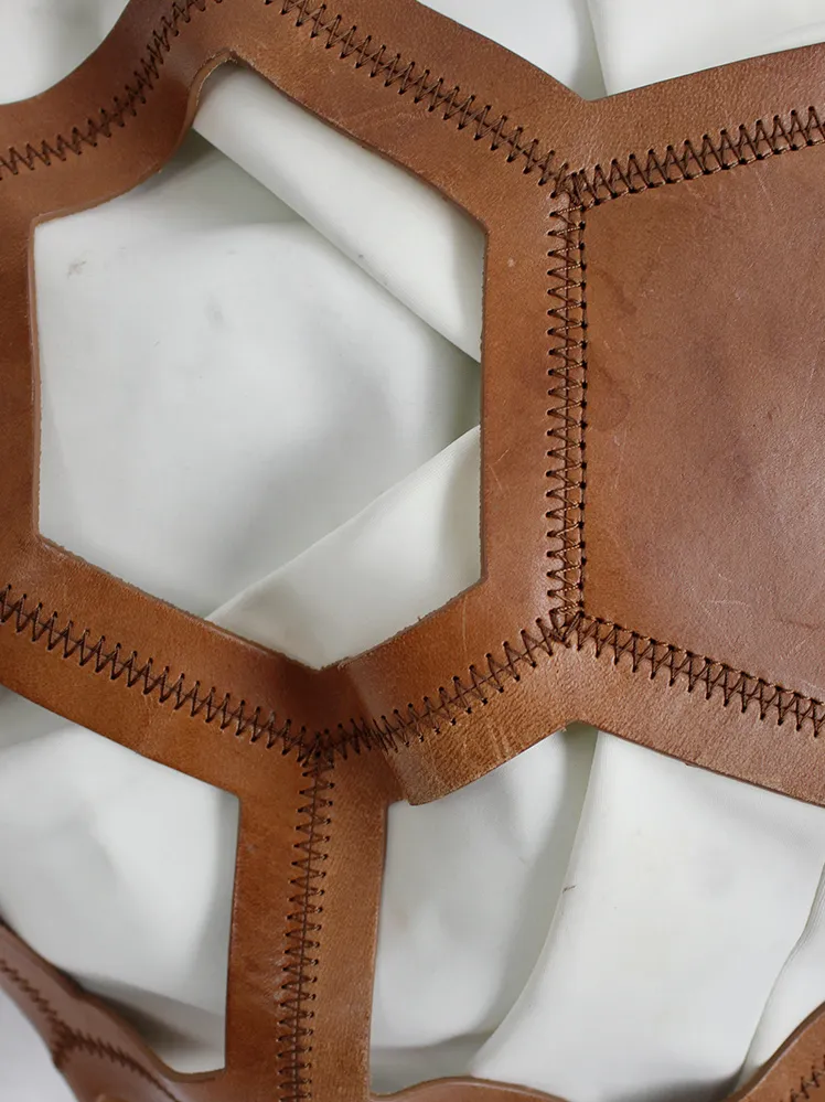 Dirk Bikkembergs brown leather football bag with hexagonal cutouts over a white fabric bag