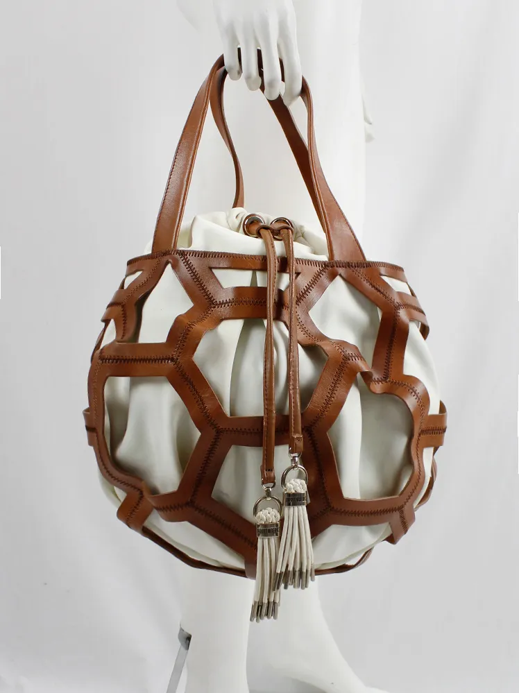 Dirk Bikkembergs brown leather football bag with hexagonal cutouts over a white fabric bag