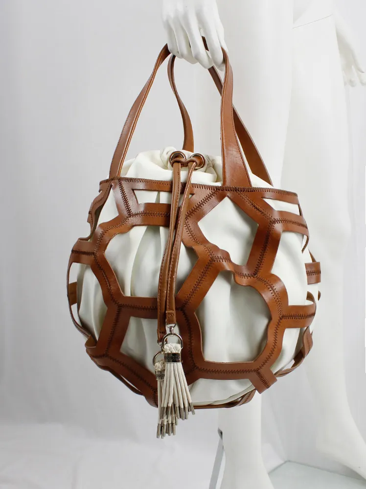 Dirk Bikkembergs brown leather football bag with hexagonal cutouts over a white fabric bag