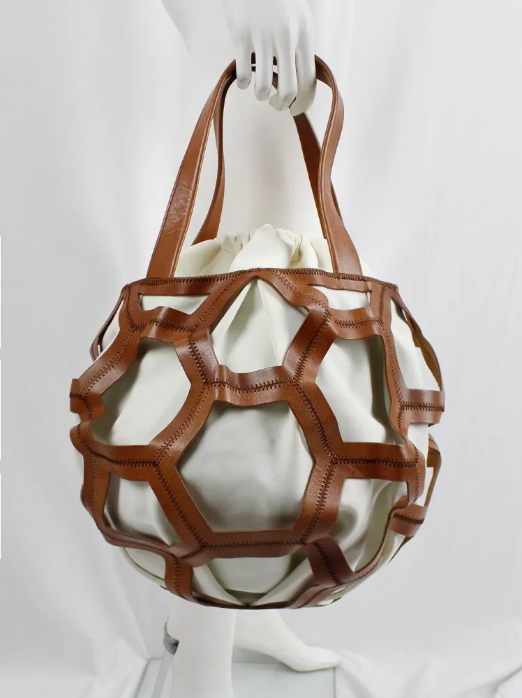 Dirk Bikkembergs brown leather football bag with hexagonal cutouts over a white fabric bag