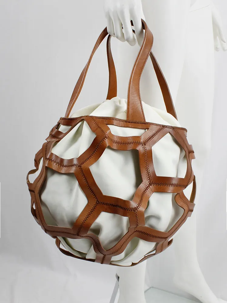 Dirk Bikkembergs brown leather football bag with hexagonal cutouts over a white fabric bag